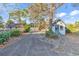 A charming home features a welcoming blue door and mature landscaping at 1800 Glenns Bay Rd., Surfside Beach, SC 29575