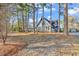 Charming home with a blue door framed by tall trees and a beautifully landscaped front yard at 1800 Glenns Bay Rd., Surfside Beach, SC 29575