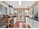 Bright and sunny kitchen with white cabinets, and a door leading to the backyard at 1800 Glenns Bay Rd., Surfside Beach, SC 29575