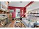 Cozy living room featuring a brick fireplace, hardwood floors, and comfortable seating arrangement at 1800 Glenns Bay Rd., Surfside Beach, SC 29575