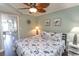 Relaxing bedroom with blue and white seashell bedding, ceiling fan, and closet access at 2001 S Ocean Blvd. # 405, Myrtle Beach, SC 29577