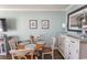 Charming dining area with wood table, seating for four, and coastal-themed artwork at 2001 S Ocean Blvd. # 405, Myrtle Beach, SC 29577