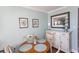 Inviting dining area features a round wood table, seating for four, and beachy decor at 2001 S Ocean Blvd. # 405, Myrtle Beach, SC 29577