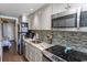 Modern kitchen with stainless steel appliances, granite countertops, and stylish backsplash at 2001 S Ocean Blvd. # 405, Myrtle Beach, SC 29577