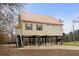 Exterior of raised river home with a metal roof, providing covered parking and entertainment space at 202 Cypress Knee Ct., Conway, SC 29526