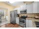 Modern kitchen features stainless steel appliances, granite counters, and white cabinetry at 202 Cypress Knee Ct., Conway, SC 29526