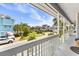 View from the balcony overlooking a street with houses, palm trees and parked cars at 202 Old Harbour Ct., Little River, SC 29566