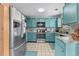 Bright kitchen with stainless steel appliances, aqua blue cabinets, and mosaic backsplash at 202 Old Harbour Ct., Little River, SC 29566