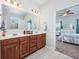 Bathroom featuring double vanity sinks, wood cabinets and tile floors at 2051 Lindrick Ct., Calabash, NC 28467