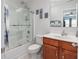 Cozy bathroom featuring a shower and a vanity with decorative signs and a framed mirror at 2051 Lindrick Ct., Calabash, NC 28467