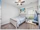 Comfortable bedroom with a ceiling fan, a bed, and a window with curtains for natural light at 2051 Lindrick Ct., Calabash, NC 28467