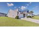 A well-maintained one-story home with an attached two-car garage and lush green lawn at 2051 Lindrick Ct., Calabash, NC 28467