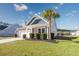 Charming single-story home featuring a well-manicured lawn and a welcoming front porch with inviting chairs at 2051 Lindrick Ct., Calabash, NC 28467