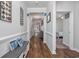 Well-lit foyer featuring hardwood floors, soft gray walls, and a decorative bench with blue pillows at 2051 Lindrick Ct., Calabash, NC 28467