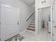 Open hallway features hardwood stairs and leads to the laundry room with modern washer and dryer at 2051 Lindrick Ct., Calabash, NC 28467