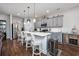 Modern kitchen featuring gray cabinets, a large island with seating, and stainless steel appliances at 2051 Lindrick Ct., Calabash, NC 28467