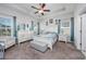 Spacious main bedroom featuring tray ceiling, carpeted floor, and an ensuite bathroom at 2051 Lindrick Ct., Calabash, NC 28467