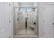 Tiled shower with glass doors and a built-in seat at 2051 Lindrick Ct., Calabash, NC 28467