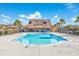 Large community swimming pool surrounded by lounge chairs and a clubhouse at 2051 Lindrick Ct., Calabash, NC 28467