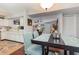 Inviting dining area with wood table, seating, and view into the living area and modern kitchen at 2270 Vereen Circle, Little River, SC 29566