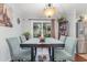 Cozy dining room featuring a wood table, soft blue chairs, and views of the backyard at 2270 Vereen Circle, Little River, SC 29566