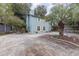 Charming two-story home featuring light blue siding, yellow shutters, and a paved driveway at 2270 Vereen Circle, Little River, SC 29566