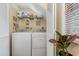 Efficient laundry room with washer, dryer, and storage shelves behind bi-fold doors at 2270 Vereen Circle, Little River, SC 29566