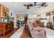 Bright living room featuring hardwood floors, a comfortable sofa, and views into the dining room and kitchen at 2270 Vereen Circle, Little River, SC 29566