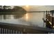 Calm waterfront view with a dock and a serene sunset reflection on the water at 2270 Vereen Circle, Little River, SC 29566