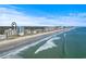 Beautiful aerial view of the coastline featuring condos, the beach and the blue ocean waters under a partly cloudy sky at 2301 S Ocean Blvd. # 1401, North Myrtle Beach, SC 29582