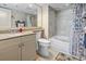 Well-lit bathroom with a tub, toilet, vanity, and a large mirror at 2301 S Ocean Blvd. # 1401, North Myrtle Beach, SC 29582