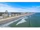 Stunning aerial view of beachfront condos with ocean views and sandy shores under a clear blue sky at 2301 S Ocean Blvd. # 1401, North Myrtle Beach, SC 29582