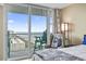 Inviting bedroom boasts a private balcony with stunning ocean views at 2301 S Ocean Blvd. # 1401, North Myrtle Beach, SC 29582