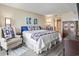 Comfortable bedroom featuring a queen bed, chair, hardwood floors and attached bathroom at 2301 S Ocean Blvd. # 1401, North Myrtle Beach, SC 29582