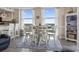 Charming dining area showcasing a round table, seating for six, and lovely natural light streaming through large windows at 2301 S Ocean Blvd. # 1401, North Myrtle Beach, SC 29582