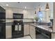 Modern kitchen with granite counters and black appliances at 2301 S Ocean Blvd. # 1401, North Myrtle Beach, SC 29582
