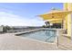 Exterior pool view with shaded lounge chairs under sunshades with ocean and sky in the background and a tiled patio at 2301 S Ocean Blvd. # 1401, North Myrtle Beach, SC 29582