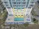 Aerial view of the condo's outdoor pool and hot tub with lounge chairs and umbrellas for relaxation at 2301 S Ocean Blvd. # 1401, North Myrtle Beach, SC 29582