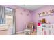 A Bedroom with light purple walls featuring a neutral glider and white shelving with decor at 242 Timber Oaks Dr., Myrtle Beach, SC 29588