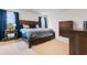 Serene bedroom with dark wood furniture and matching dark blue accents at 242 Timber Oaks Dr., Myrtle Beach, SC 29588