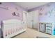 This bedroom features pastel purple walls, a white crib, and a changing table at 242 Timber Oaks Dr., Myrtle Beach, SC 29588