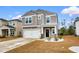 Charming two-story home with a two-car garage and a well-maintained front lawn featuring winter grass at 242 Timber Oaks Dr., Myrtle Beach, SC 29588