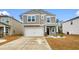Two-story home featuring a two-car garage, manicured lawn, and neutral siding, offering classic curb appeal at 242 Timber Oaks Dr., Myrtle Beach, SC 29588