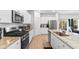 Modern kitchen featuring granite countertops, stainless steel appliances, and a kitchen island with a sink at 242 Timber Oaks Dr., Myrtle Beach, SC 29588