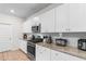 Bright, functional kitchen with white cabinetry, granite countertops, stainless steel appliances, and wood floors at 242 Timber Oaks Dr., Myrtle Beach, SC 29588