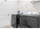 A modern laundry room features a front loading washer, dryer and overhead shelving at 242 Timber Oaks Dr., Myrtle Beach, SC 29588