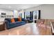 Cozy living room featuring wood floors, a comfortable blue sofa, and an open-concept design to the kitchen at 242 Timber Oaks Dr., Myrtle Beach, SC 29588