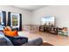 Cozy living room featuring wood floors, TV, playpen, and blue couch at 242 Timber Oaks Dr., Myrtle Beach, SC 29588