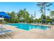 Community pool surrounded by lounge chairs and umbrellas, perfect for summer relaxation at 242 Timber Oaks Dr., Myrtle Beach, SC 29588