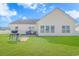 Backyard with outdoor seating, a gas grill on a brick patio, lush green grass, and nice windows at 256 Maple Oak Dr., Conway, SC 29526